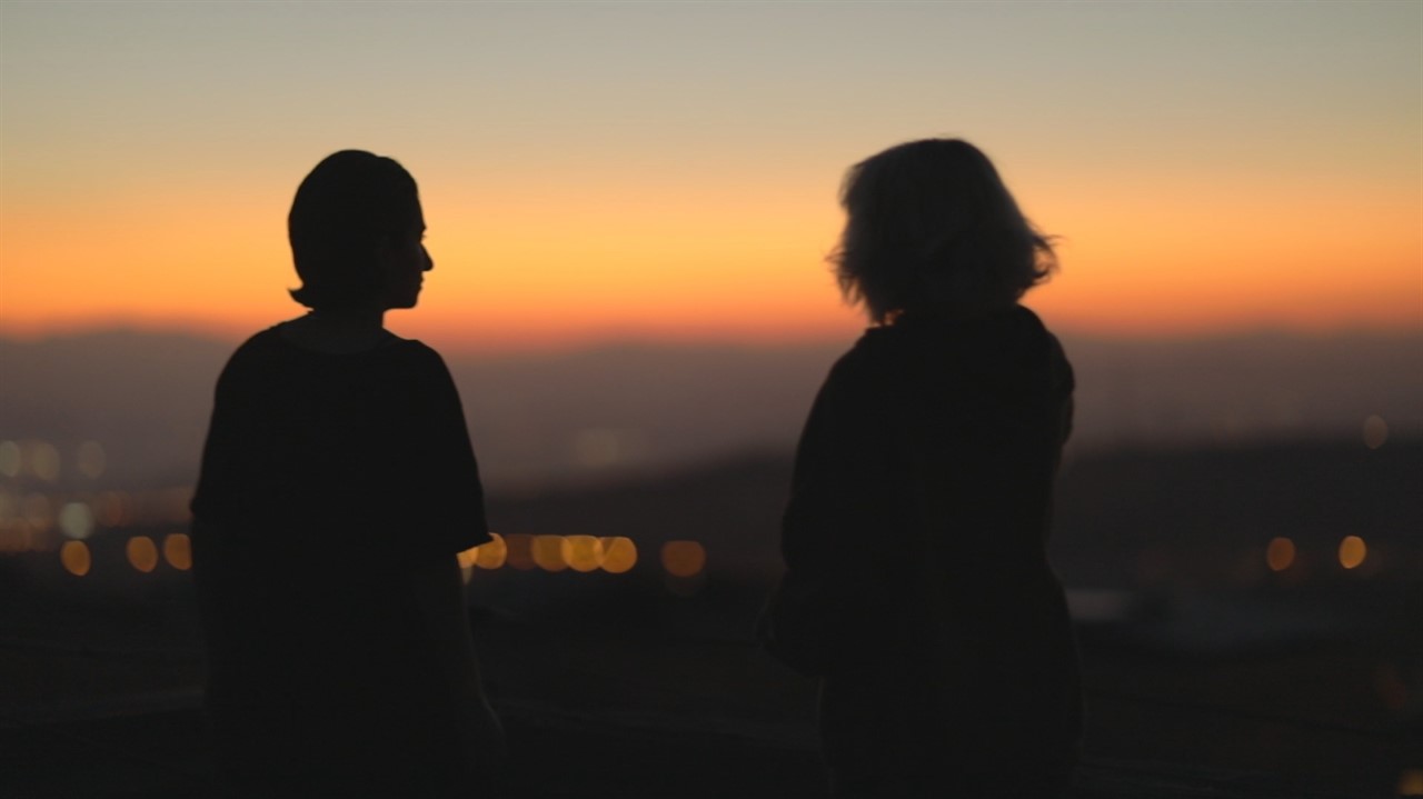 Silhouette of two people at sunset