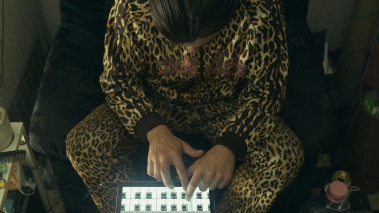 Man in leopard print pressing buttons
