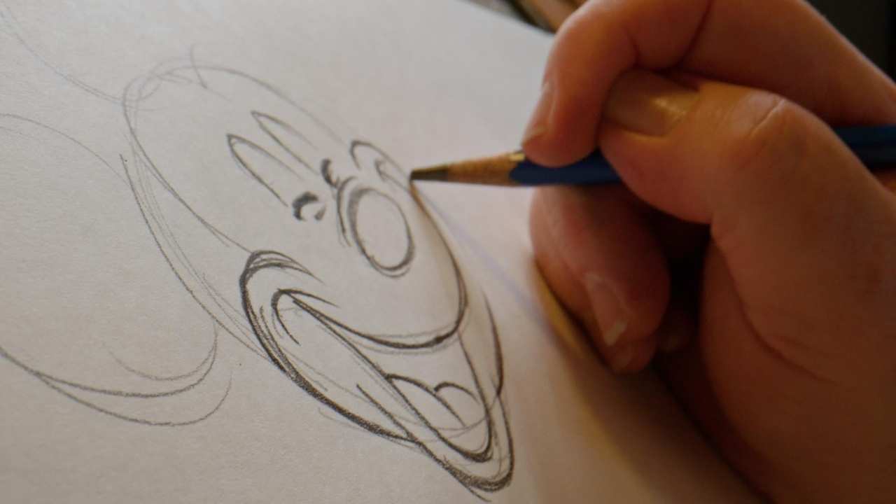 person drawing Mickey Mouse