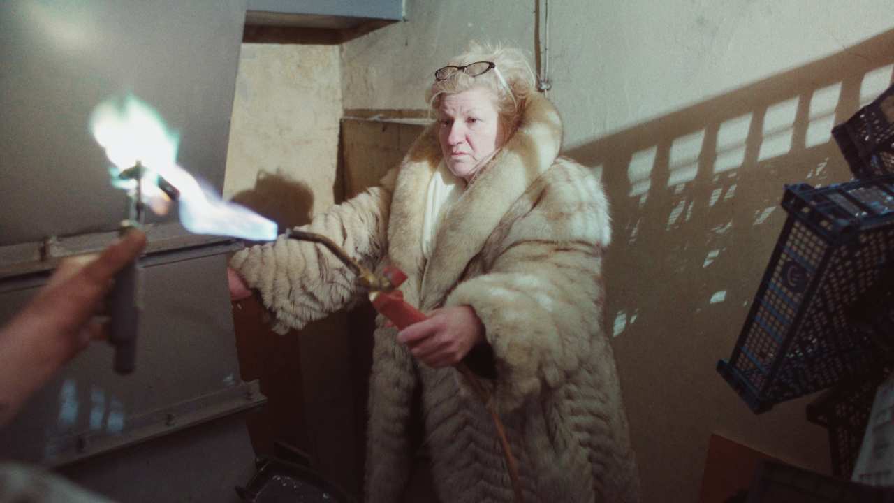 a woman in fur with a blowtorch