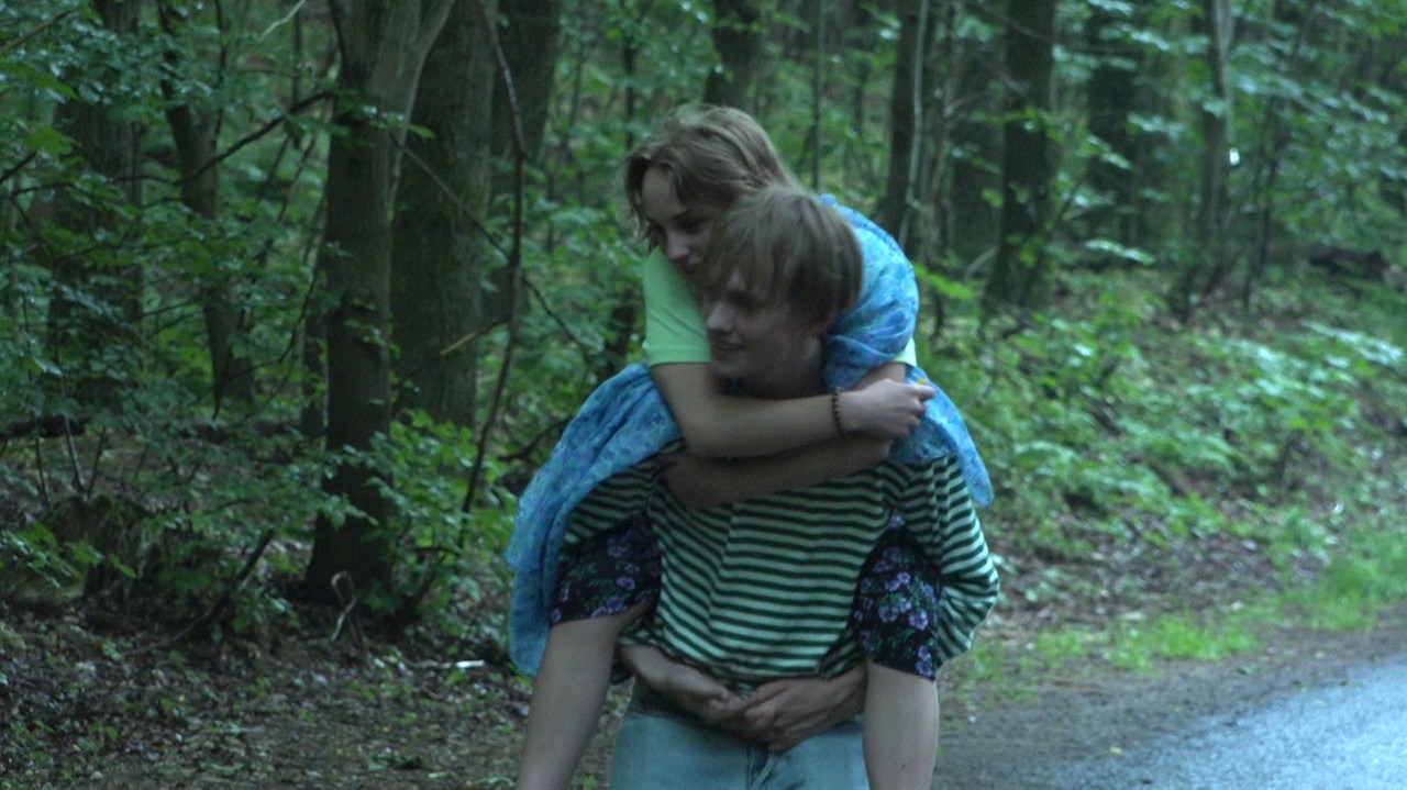 Teen boy giving a teen girl a piggyback