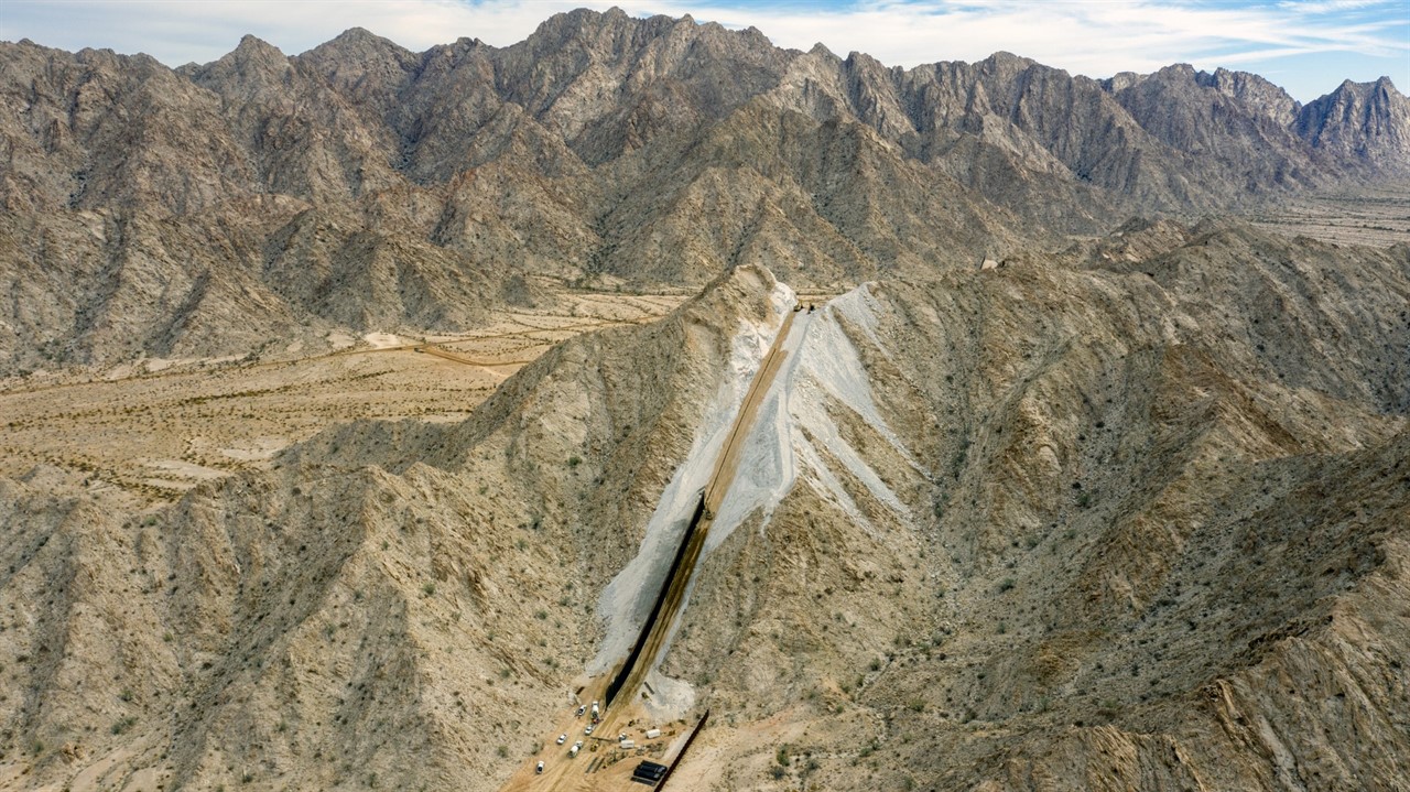 Aerial view of wall construction up a mountainside