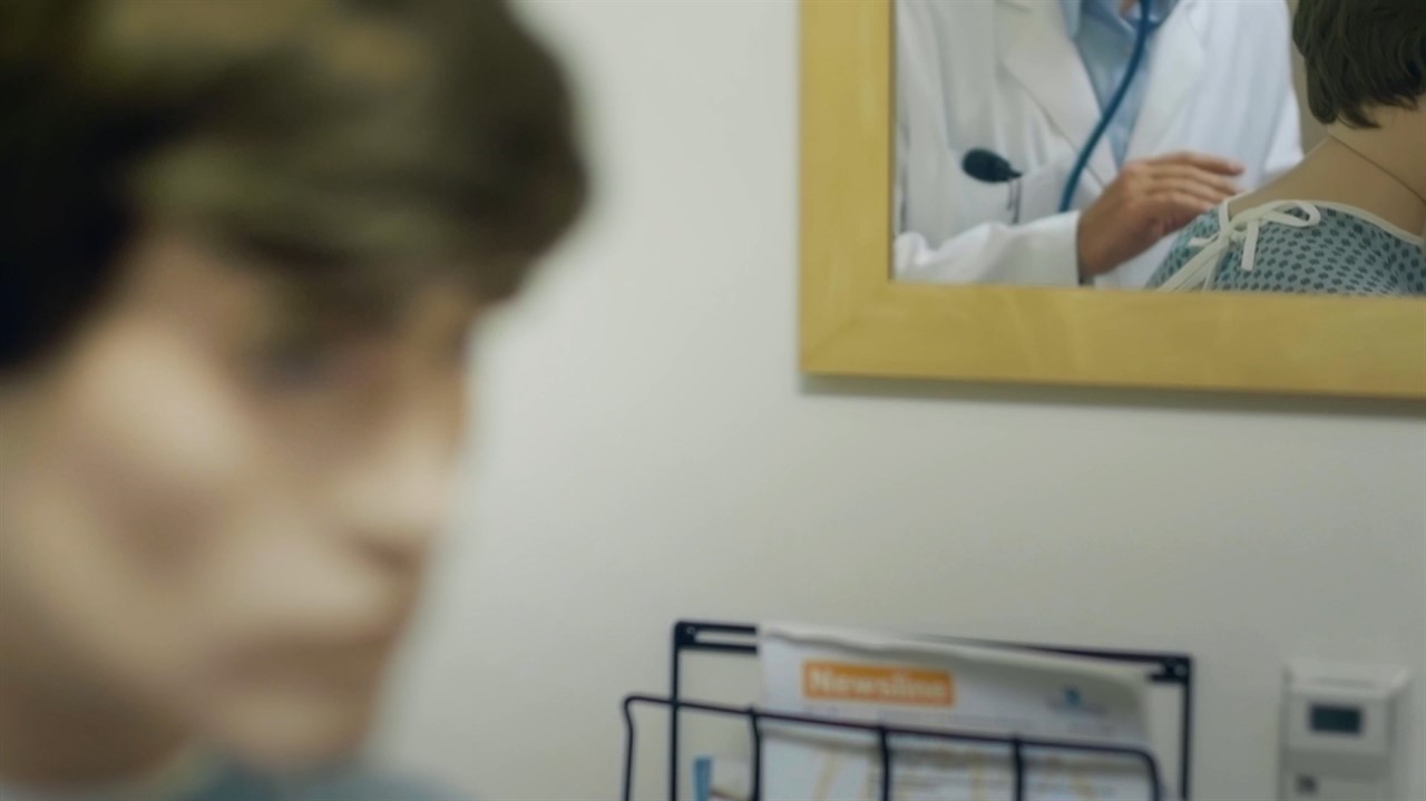 Blurry face, mirror shows a doctor
