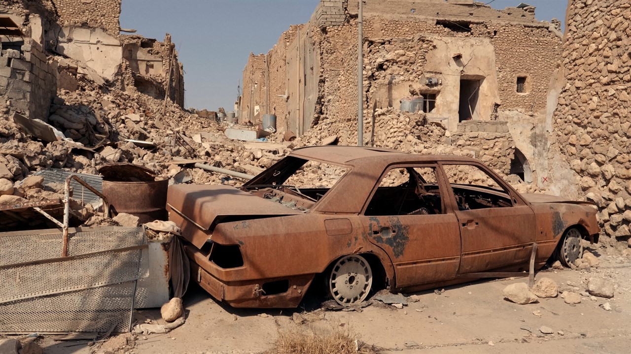 War torn buildings and car