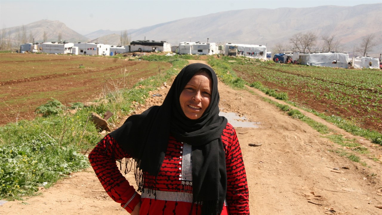 Syrian woman standing on a dirt road