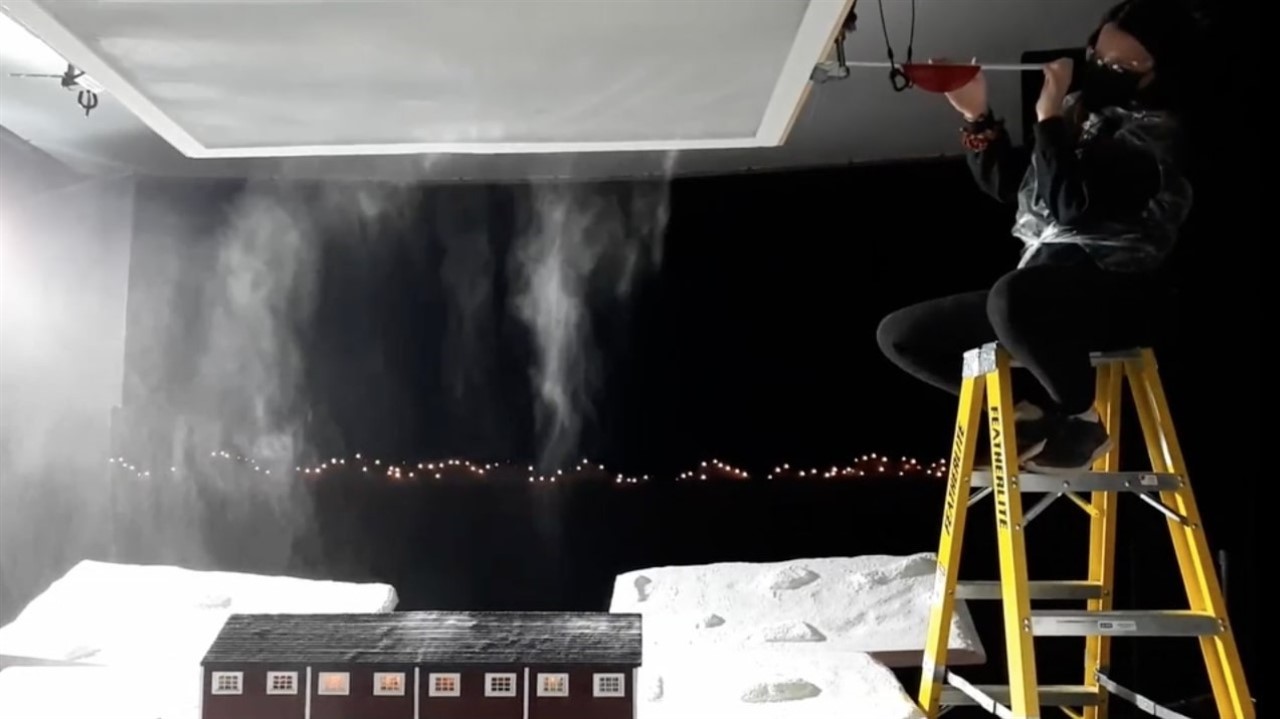 Person on a ladder setting up snow effect