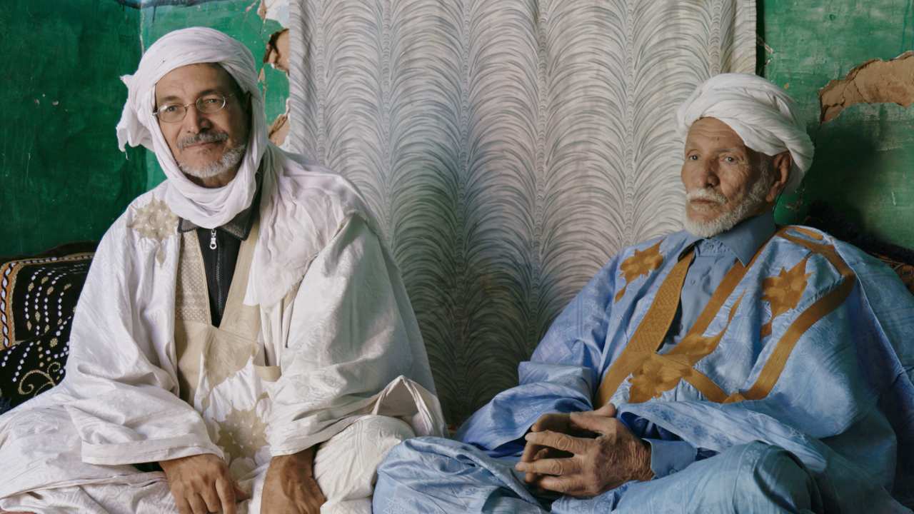 two men sitting side by side