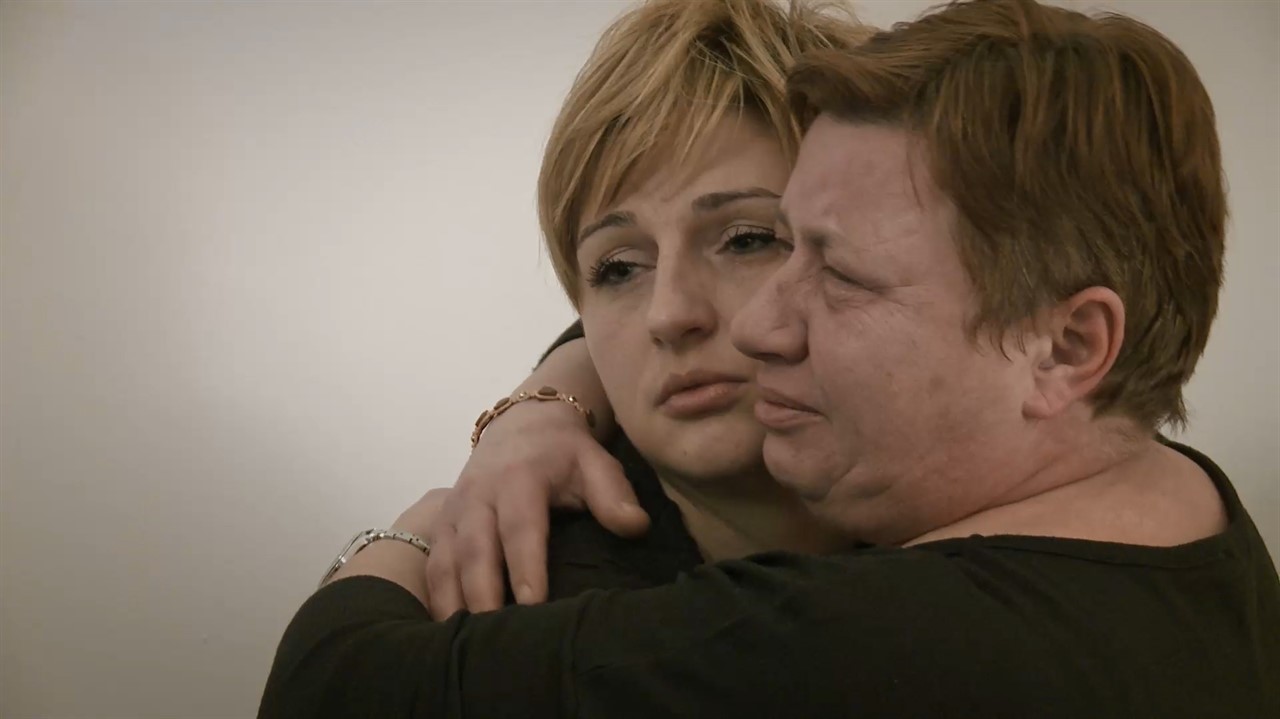 Two women embracing.
