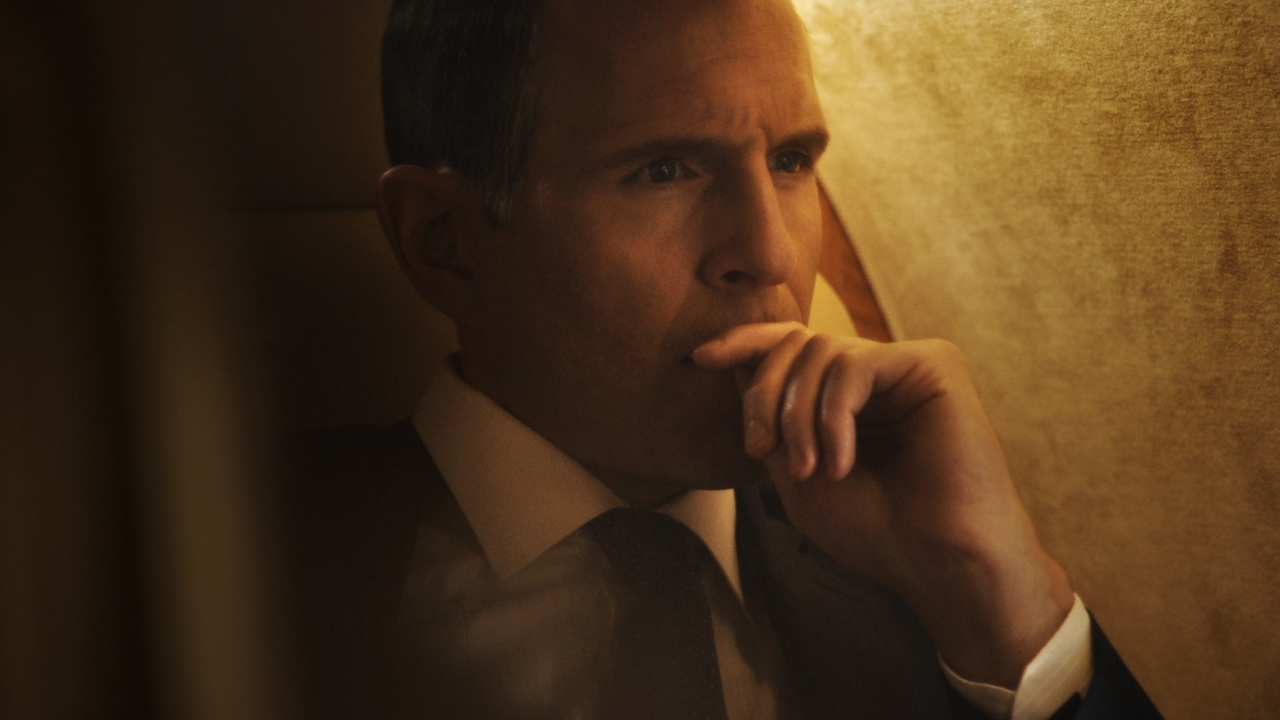 a man in a suit looking to the right