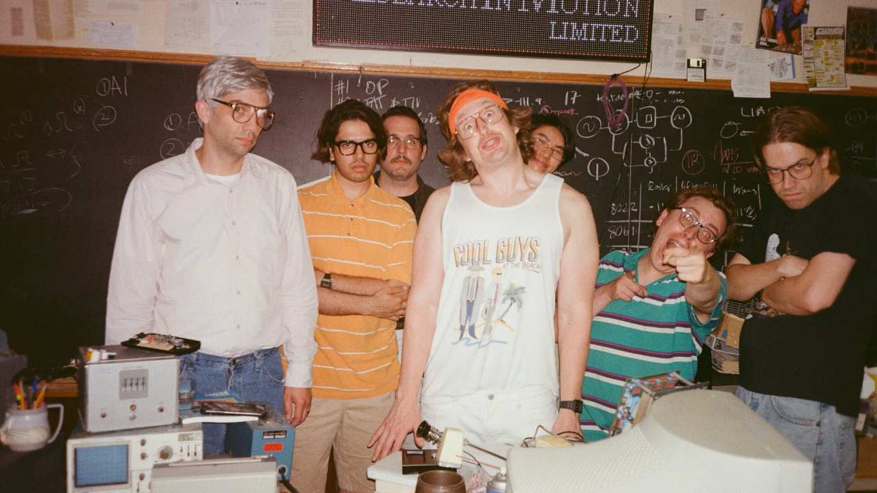 a group of men with glasses in a classroom