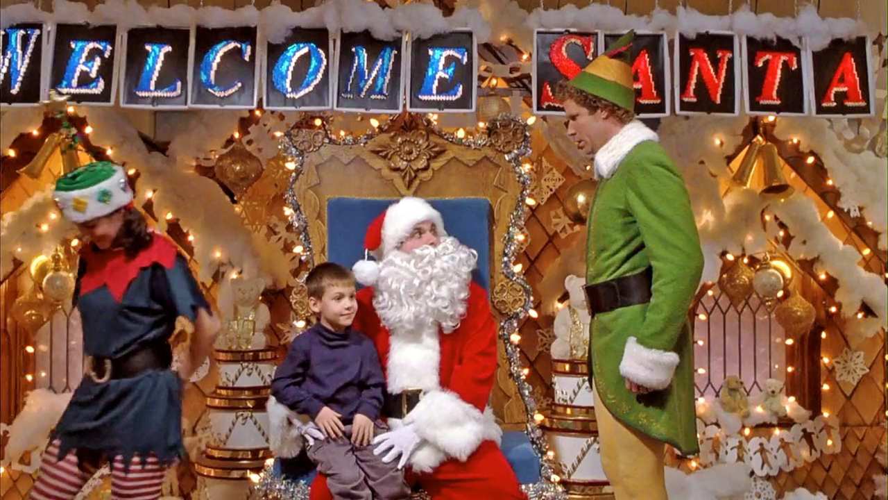 an elf talking to Santa