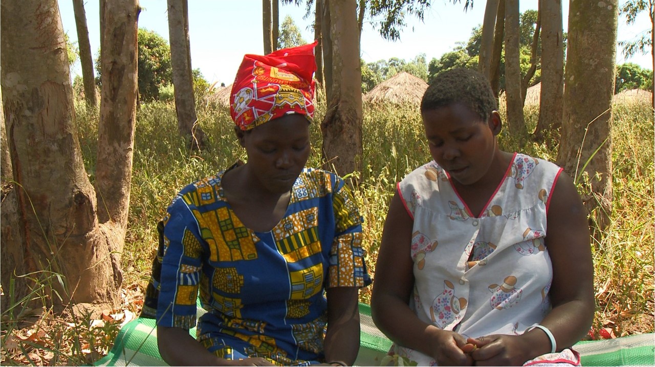 Two Ugandan women sitting outside talking