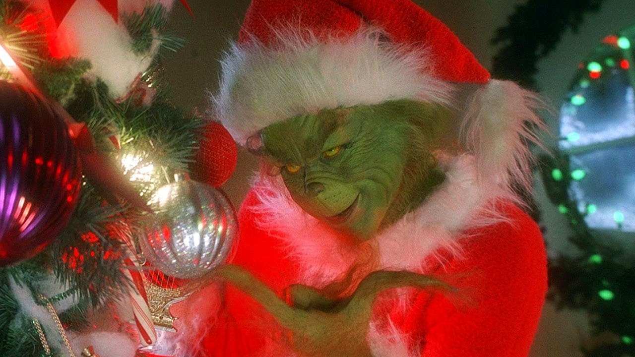 the Grinch looking at Christmas tree decorations