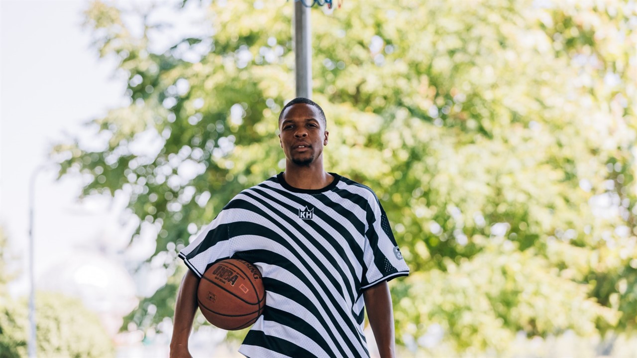 Teenage boy in a striped shirt with a basketball