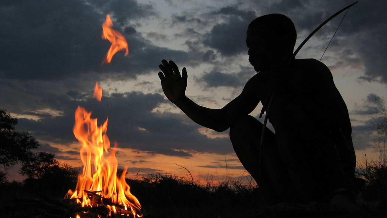 a person sitting by a fire
