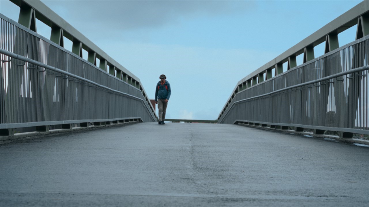 Person walks along a bridge