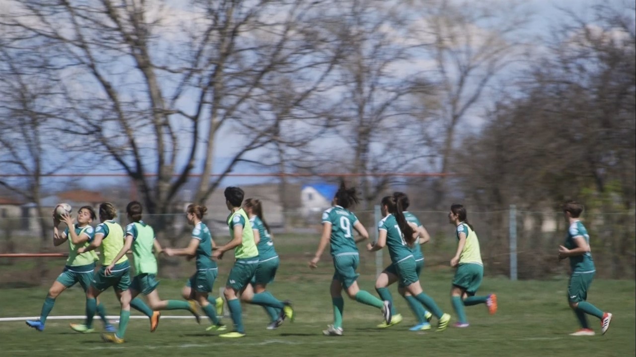 A soccer team running across a field