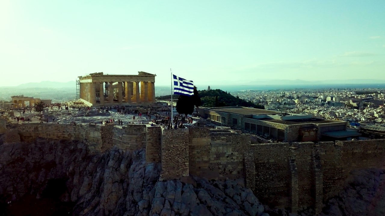 Greek flag flies in front of the Parthenon