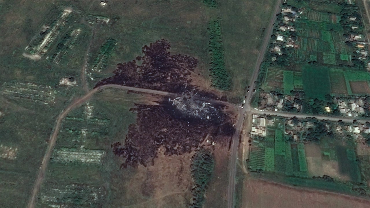 Aerial view of plane crash site in a field