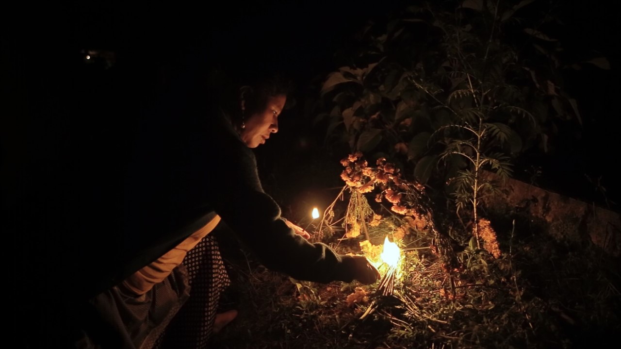 Woman at night lighting fire