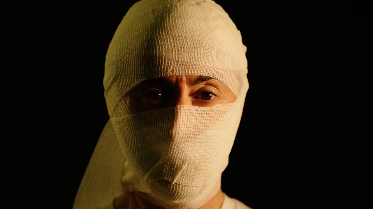 Man with face bandaged