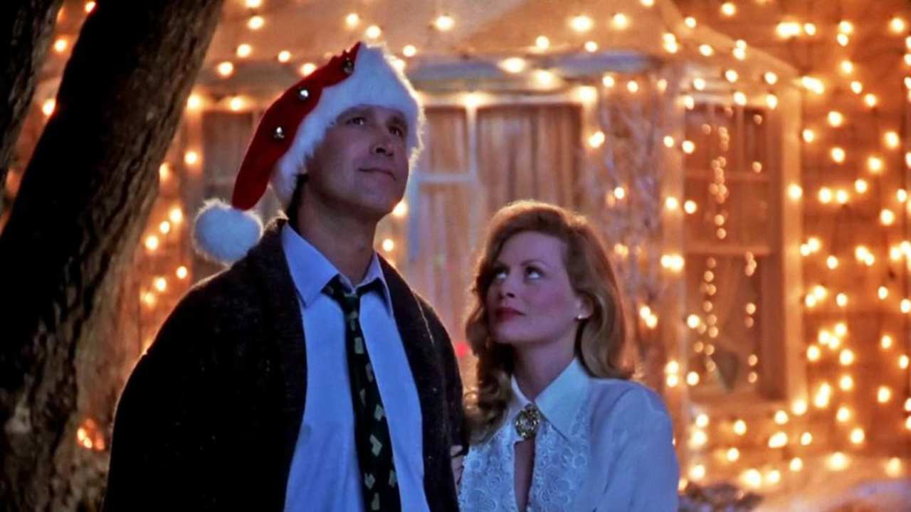 a man with a Santa hat standing with a woman