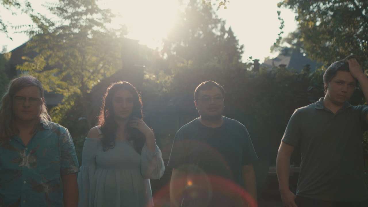 four people facing the camera
