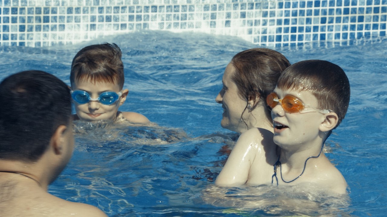 A family of four play in a pool