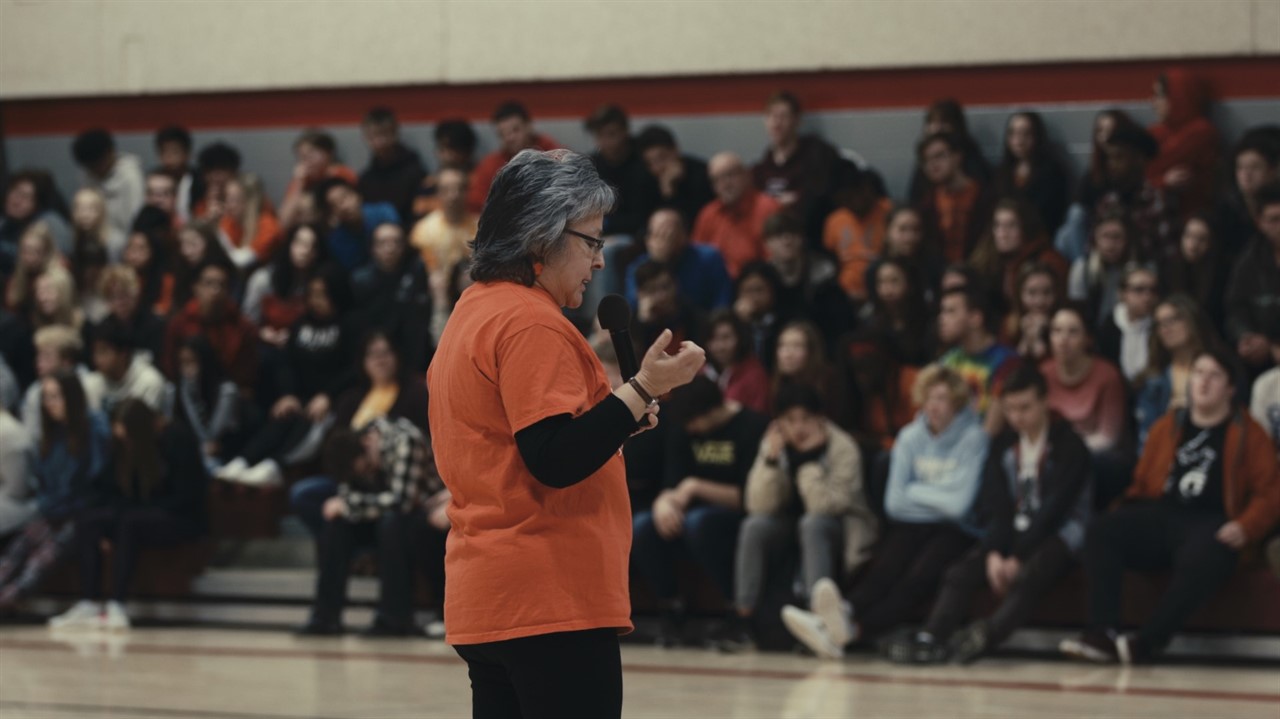 Indigenous woman speaking at a school
