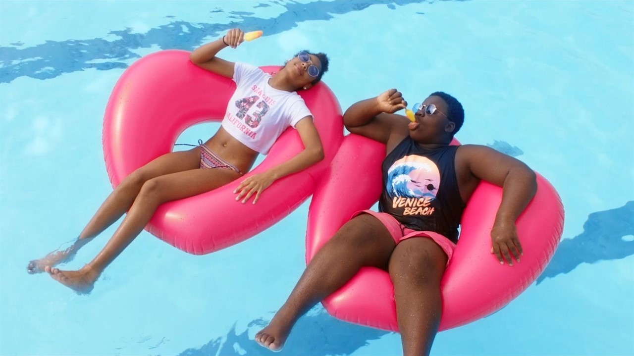 Two young people floating on inner tubes
