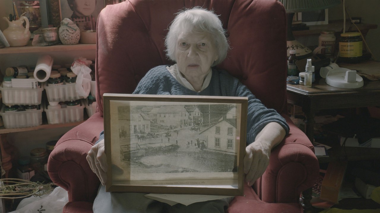 Woman sitting in a chair holding a photograph