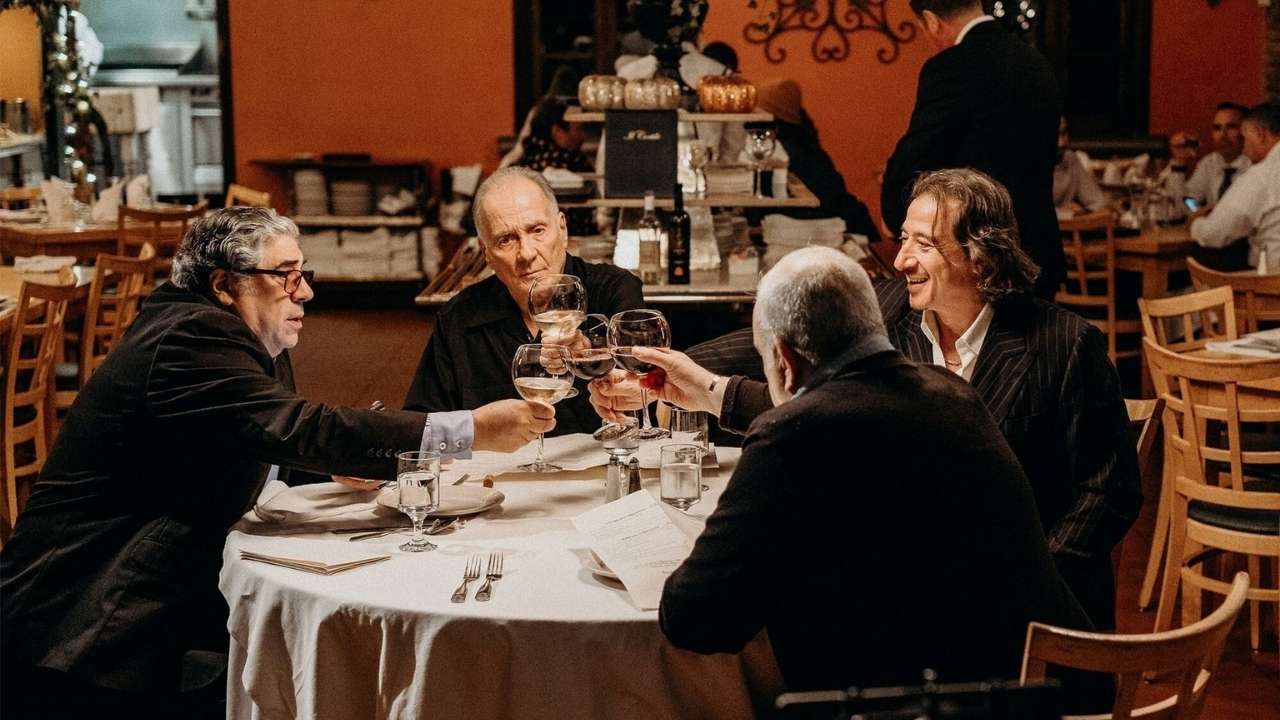 Four men clinking their wine glasses