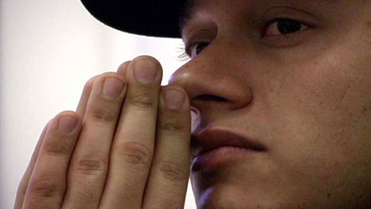 a person with their hands in front of their face