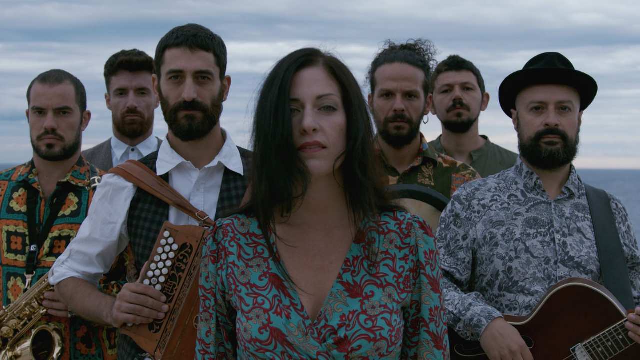 a woman and six men with musical instruments