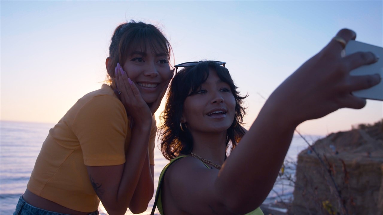 Young women taking selfie by lake
