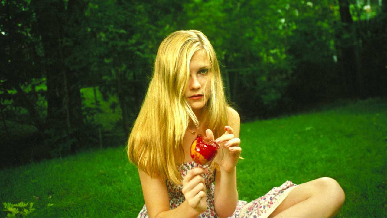 a blonde girl with a candy apple